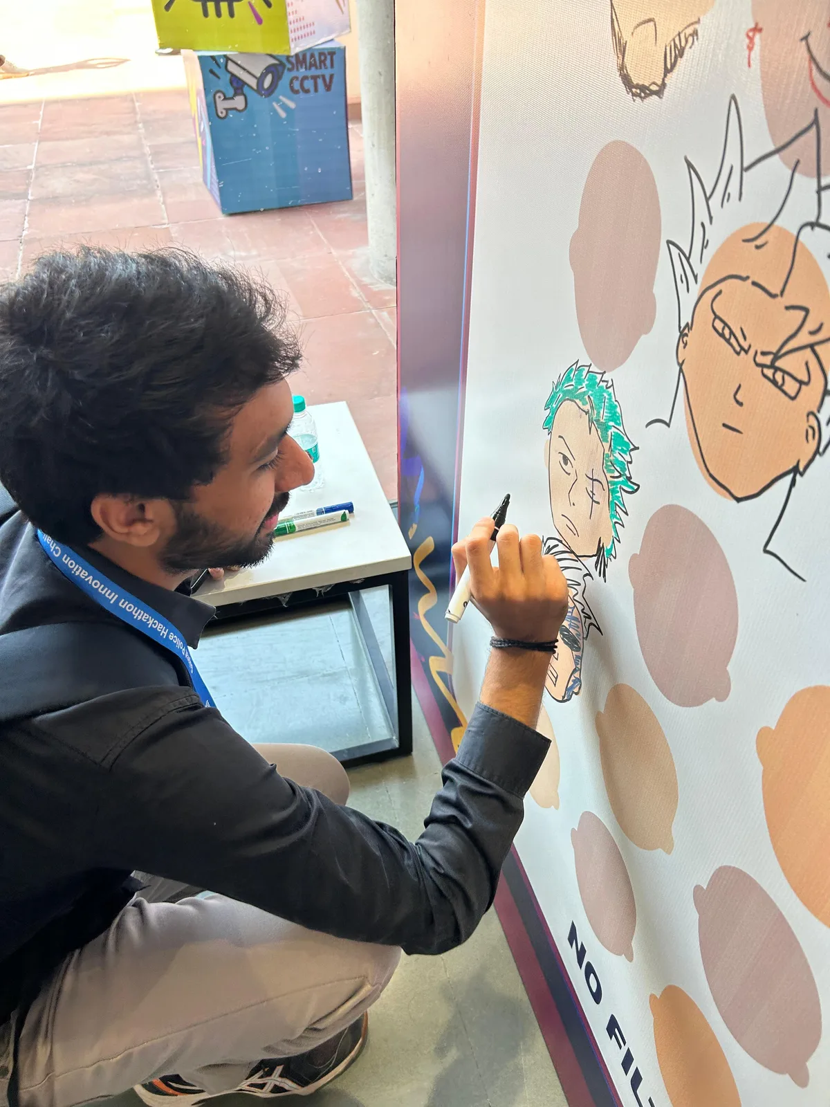 Vatsal Mehta drawing Zoro on the faces wall at Sentinel Hackathon 2026